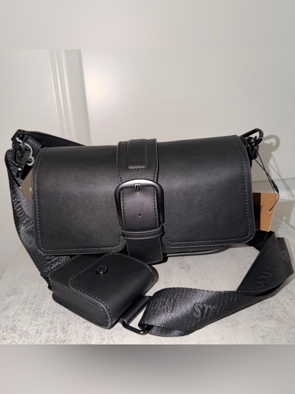 Black Steve Madden Bcharle crossbody bag with a prominent buckled strap detail